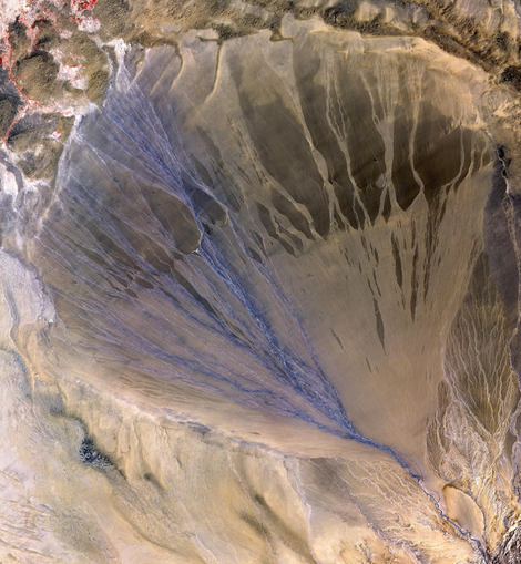 An alluvial fan as seen in China. Similar features were discovered on Titan, suggesting the presence of rainstorms. (Image: NASA)